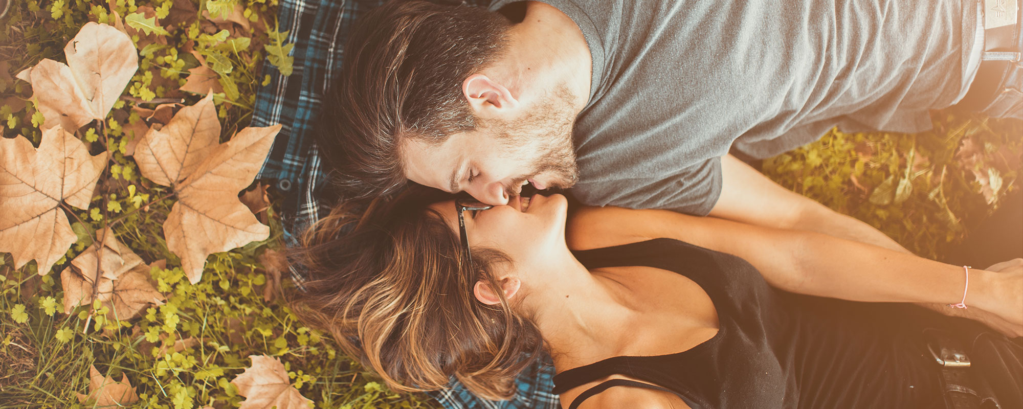 couple laying in the leaves