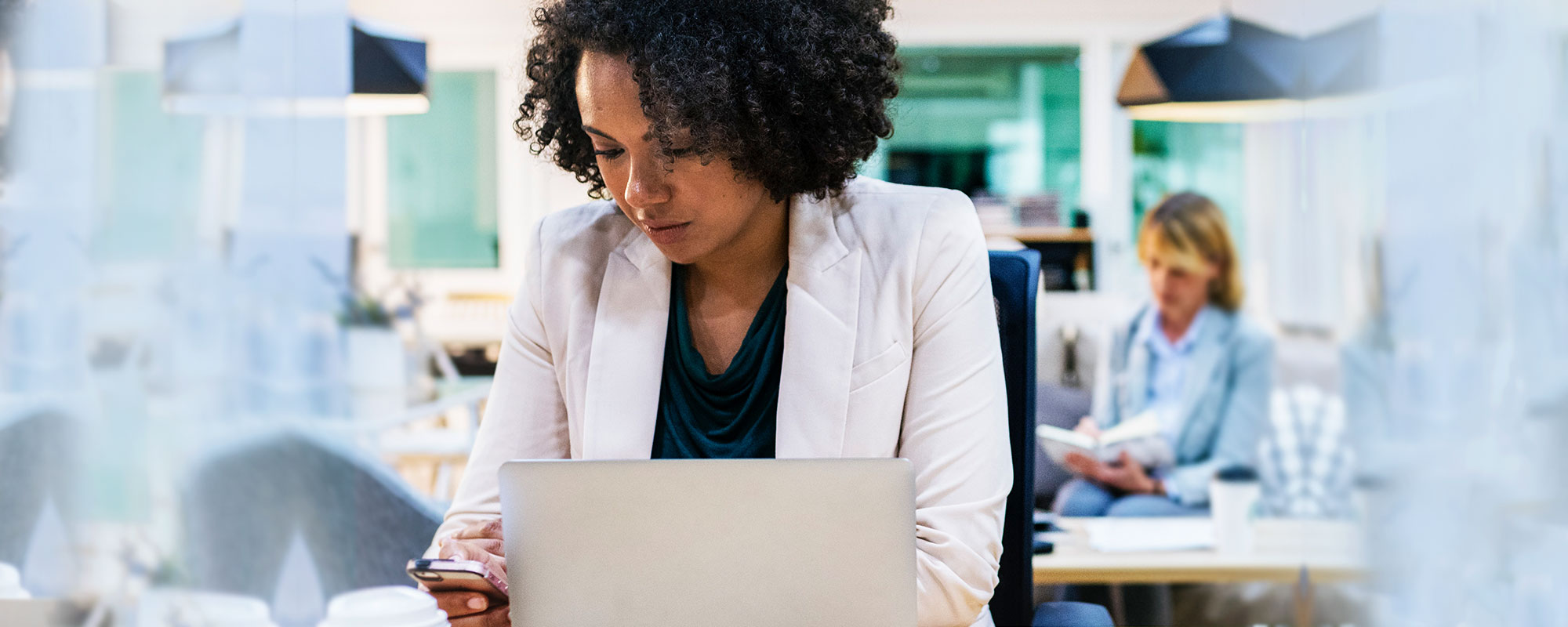 a woman with a laptop and cell phone