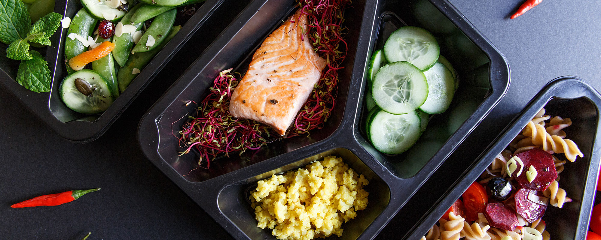 food in a black plastic tray