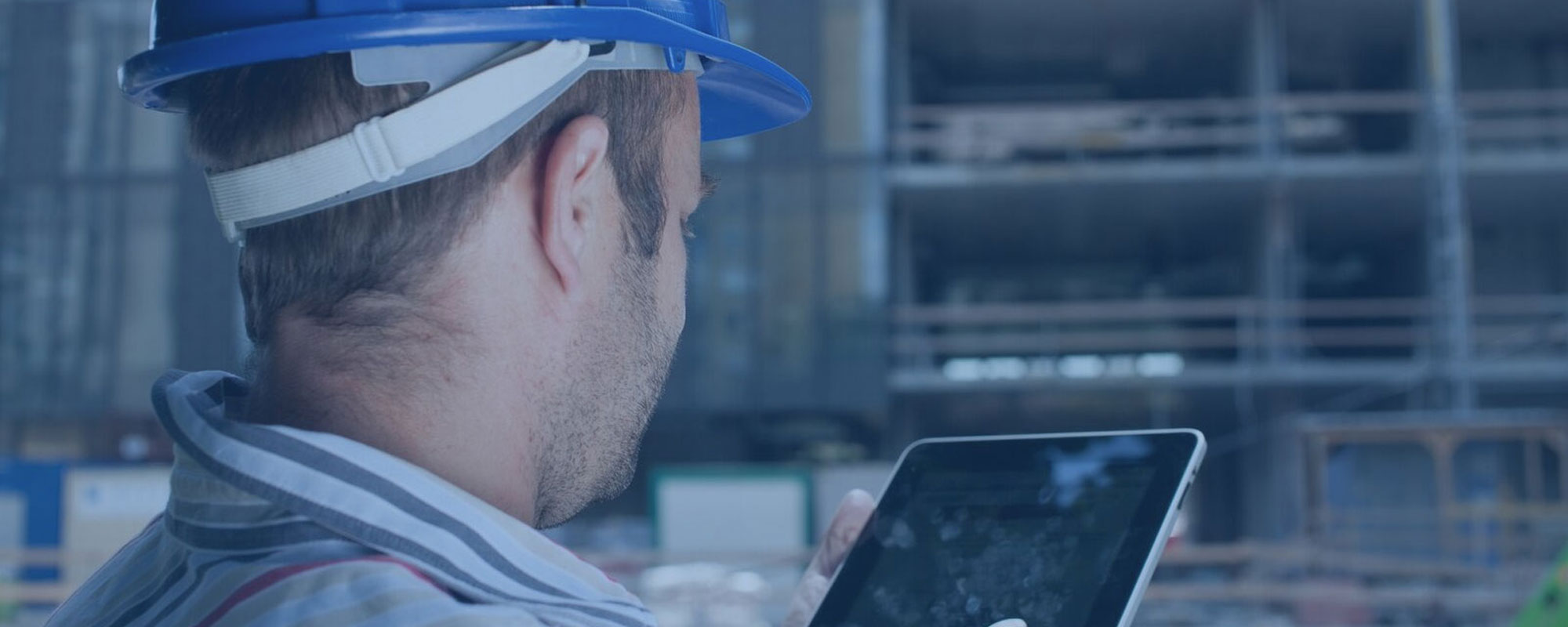Foreman looking at an tablet at a construction site