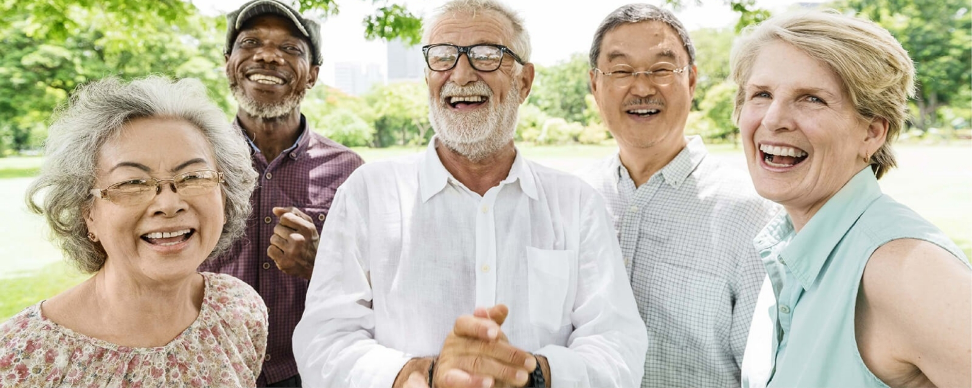 group of happy, diverse people of various ages outside