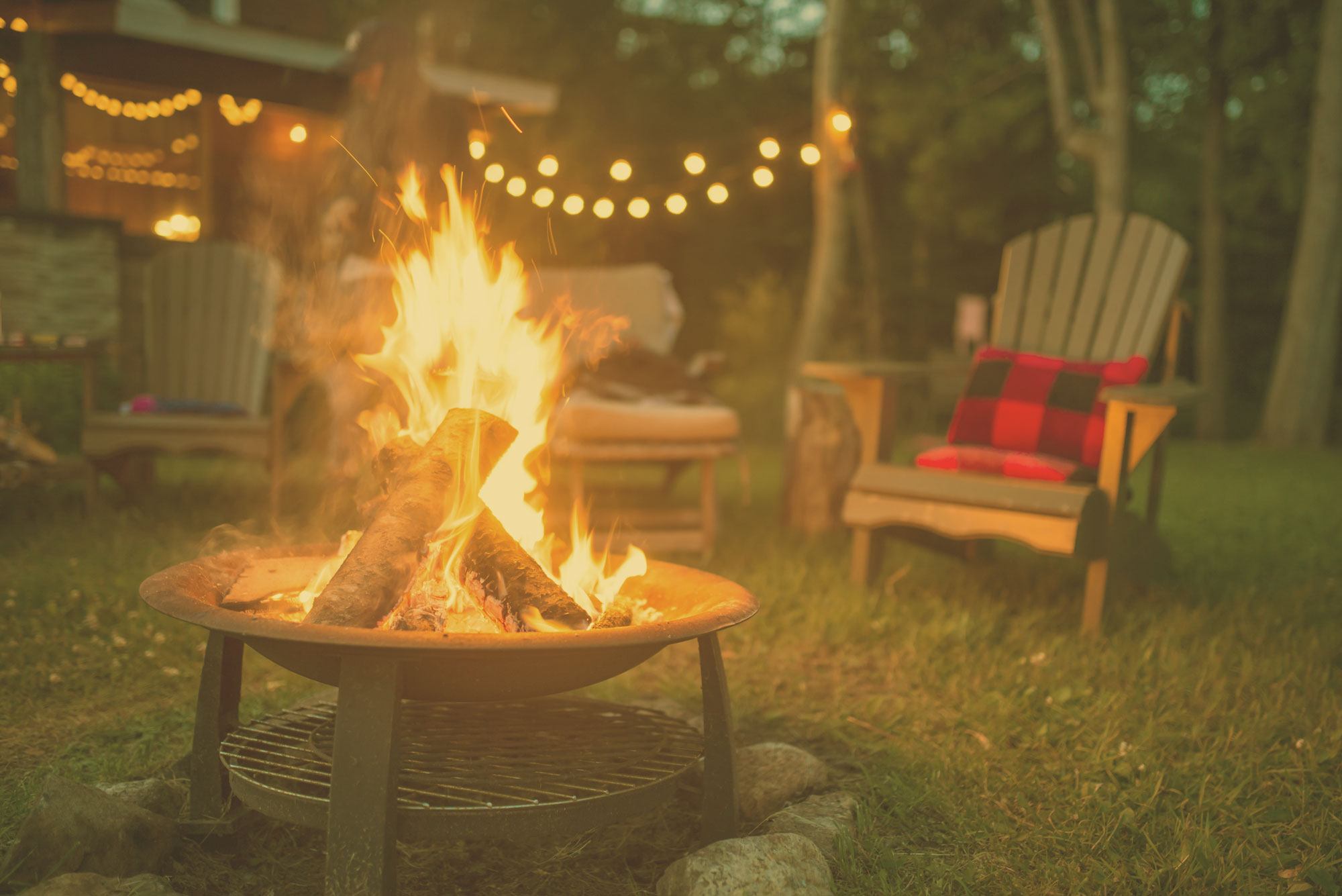 Chairs around a lit campfire
