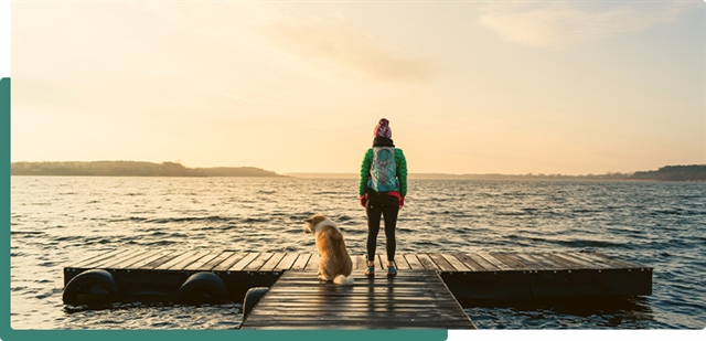 woman and dog on a pier