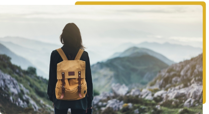 hiker with backpack looking at landscape