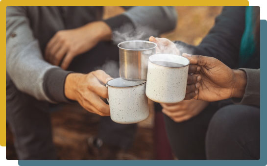 Campers holding steaming mugs